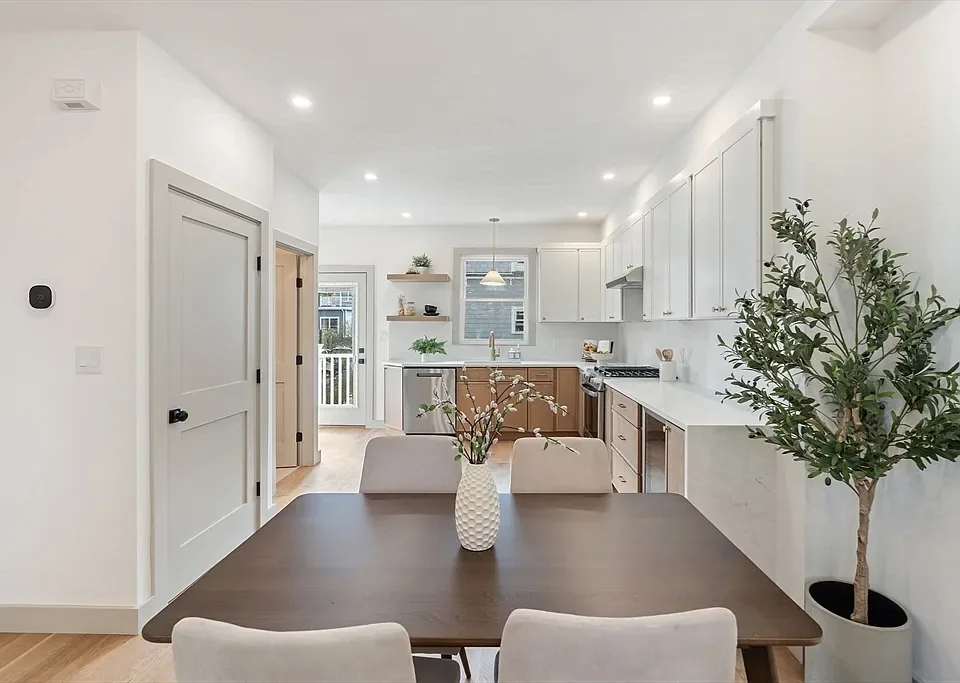 Open kitchen renovation with white cabinetry and wood finishes by KNT Construction